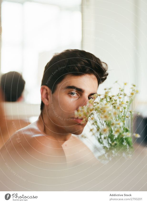 Young man with bunch of flowers in hands Man Mouth Flower Guy Fresh Youth (Young adults) Brunette White shirtless Surprise Gift romantic Daisy