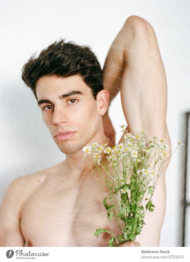 Young man with bunch of flowers in hands Man Mouth Flower Guy Fresh Youth (Young adults) Brunette White shirtless Surprise Gift romantic Daisy