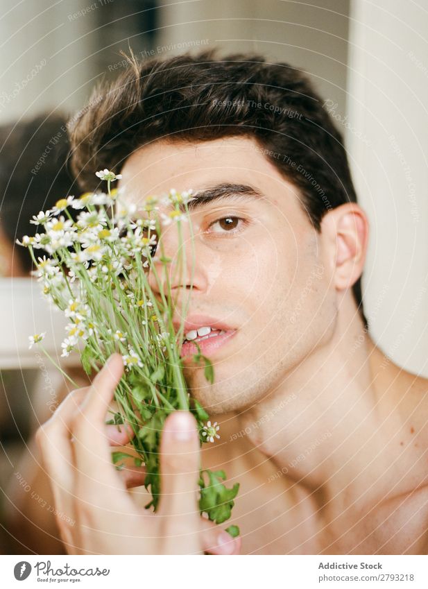 Young man with bunch of flowers in hands Man Mouth Flower Guy Fresh Youth (Young adults) Brunette White shirtless Surprise Gift romantic Daisy