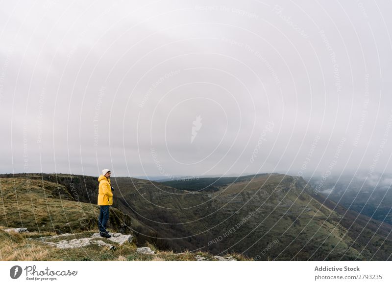 Man standing on top of hill Hill Top orduna Spain Hat Coat Yellow Mountain Sky Clouds Guy Adventure Vacation & Travel Peak Action Cliff Hiking Extreme Nature