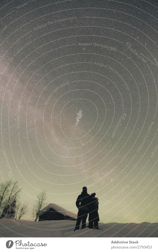 Anonymous couple looking at night sky Couple admiring Sky Night The Arctic Landscape embracing Love Together Evening Vacation & Travel Snow Cold Weather Stars