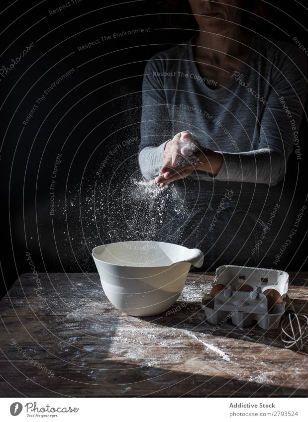 Woman clapping hands in flour near bowl and pack of eggs on table Hand Flour Bowl Egg Pack Table Applause Beater Wood Meal Craft (trade) Tasty Baked goods Lady