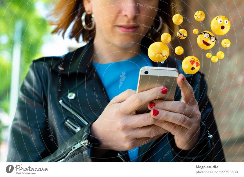 Woman using smartphone sending emojis. Lifestyle Happy Face Telephone PDA Screen Technology Internet Human being Adults Hand Funny Modern Smart Emotions young