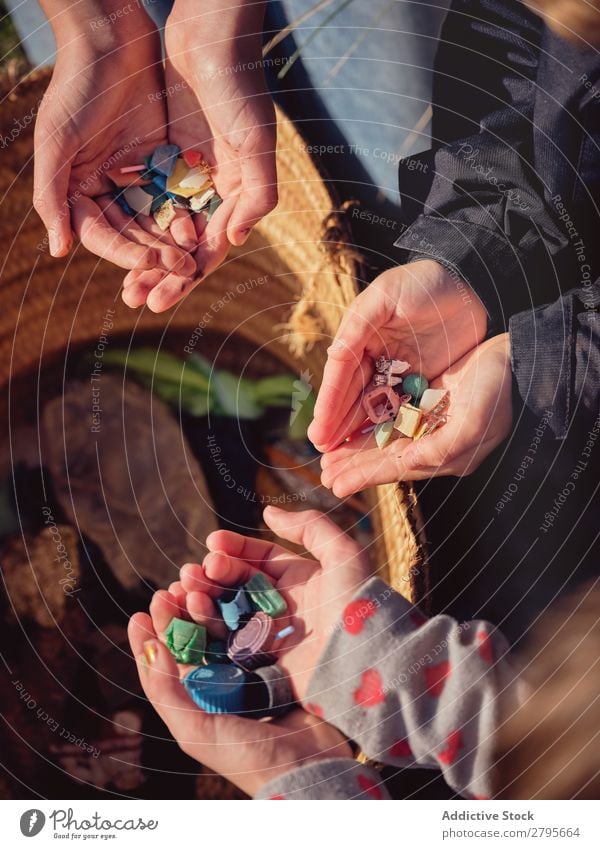 Person and children with heaps of garbage in hands near basket Trash container Heap Hand Basket Child Human being Accumulation Container Plastic cleaning up