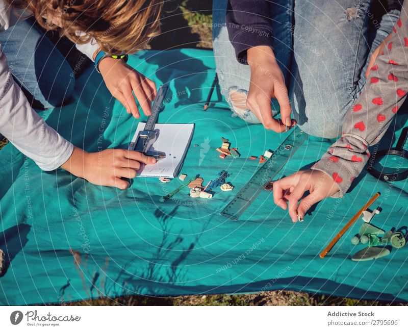 People gauging little things on paper on coverlet Human being Things Paper Plastic Hand vernier caliper Ground Environment Small measuring Trash container