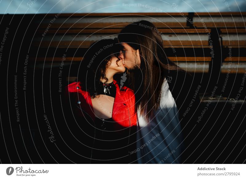 Long haired man hugging and kissing woman near train Couple abandoned wagons Embrace Railroad Graffiti old train Kissing Love Engines Hipster