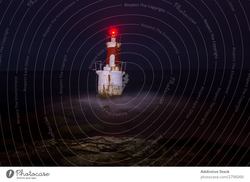 Lighthouse on rocky coastline Red Ocean Cape Stone Rock Nature Sky Coast Bay Vantage point Beautiful Beacon Building Storm Foam Fog guiding Picturesque