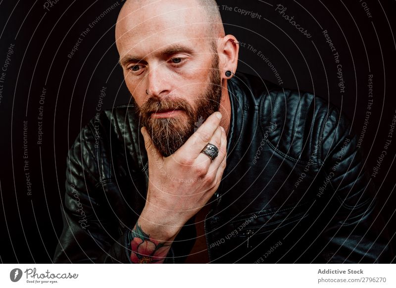 Pensive young bearded guy Man Hipster Tattoo Bald or shaved head Youth (Young adults) Guy Considerate scratching Leather jacket Hand Easygoing handsome