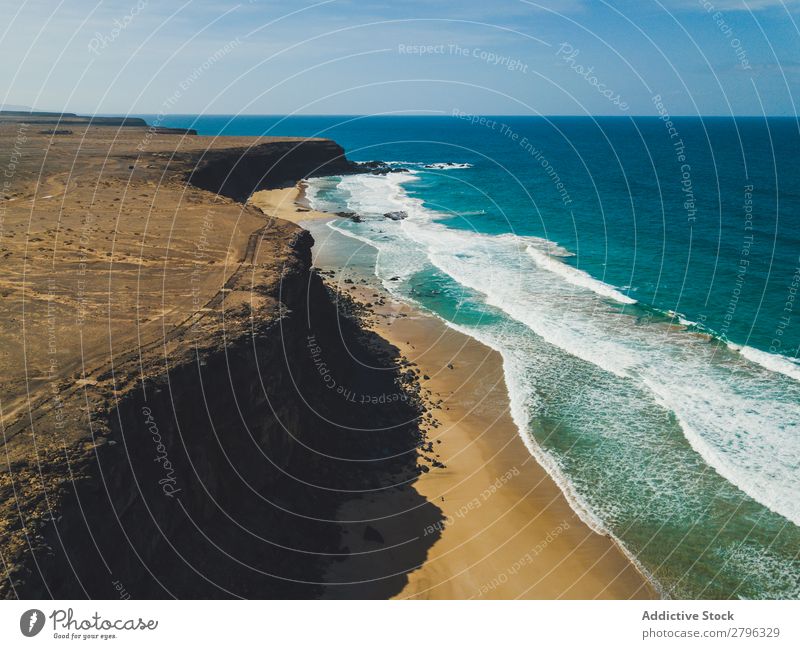 Amazing shoreline of ocean from drone Coast drone view Ocean Cliff Landscape Majestic Spain las palmas Fuerteventura Aircraft Nature Water Waves Power Turquoise