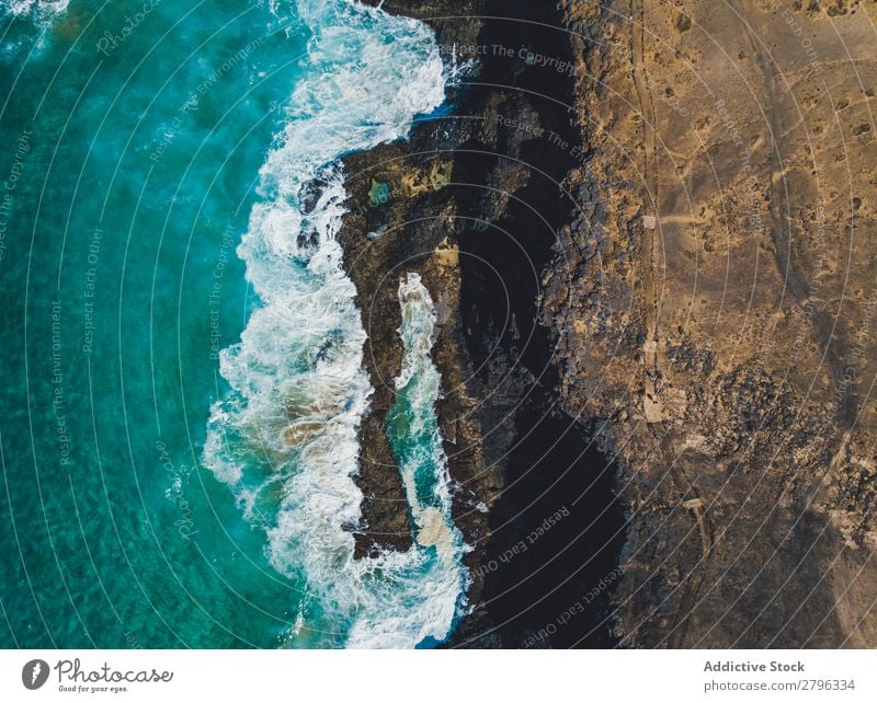 Amazing shoreline of ocean from drone Coast drone view Ocean Cliff Landscape Majestic Spain las palmas Fuerteventura Aircraft Nature Water Waves Power Turquoise