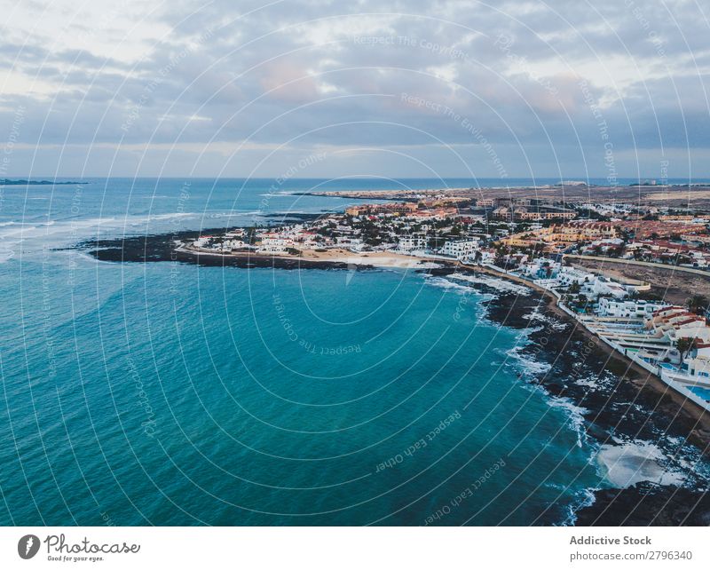 Scenic aerial view of city on ocean shore Coast City drone view Ocean Aircraft Fuerteventura las palmas Spain Picturesque Blue Sky Vacation & Travel