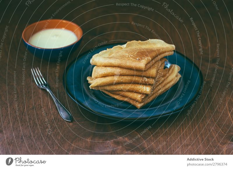 Sauce near stack of blini Stack Breakfast Russian Tradition Fork Plate Bowl Cream Pancake Rocks Crêpe Home-made Frying Baked goods Tasty Delicious yummy Fresh