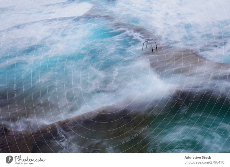 Stone shore with ladder between water Coast Water Ladder Foam hierro island Canaries Spain Ocean Surface Rock Splash Wonderful Amazing Natural Wave Nature