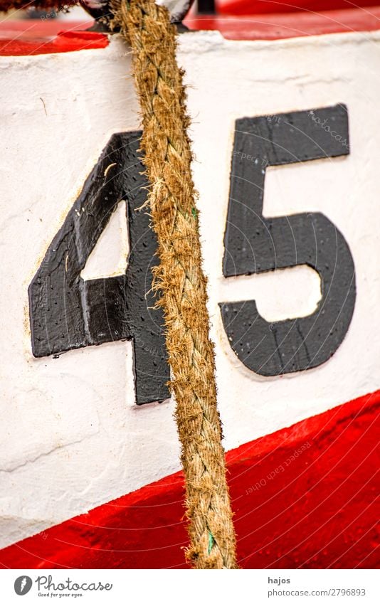 Mooring line to a red-white fishing boat Design Navigation Fishing boat Maritime mooring rope fishing cutter Red White Number 45 lashed Harbour anchored moored