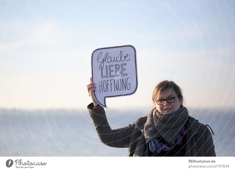 Woman holding speech bubble with faith love hope Religion and faith Speech bubble Belief Christianity Serene Responsibility Love Hope Safety (feeling of)