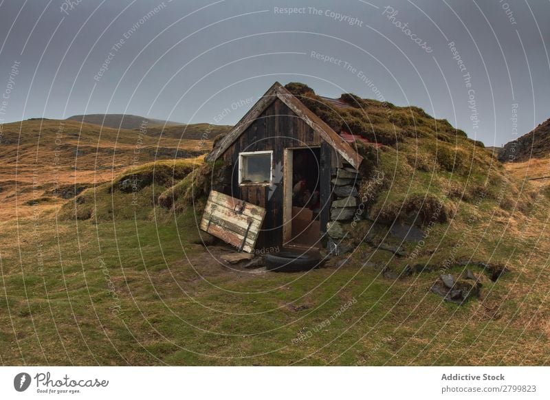 Damaged shack in countryside Hut Shabby Landscape Iceland Broken Door Moss Grass Exterior Entrance Gray Sky Dull grungy Weathered Shack