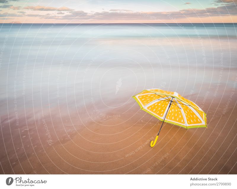 Umbrella on beach near sea Beach Ocean Sunset Evening Sky Clouds Waves Vacation & Travel Coast Sand Trip Tourism Dusk Twilight Water Paradise Resort Sunshade