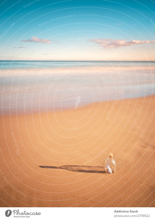 Bottle in sand near sea Letters (alphabet) Sand Ocean Coast Sky Beach Summer Water Vacation & Travel Trip Tourism Deserted Communication Paradise Harmonious