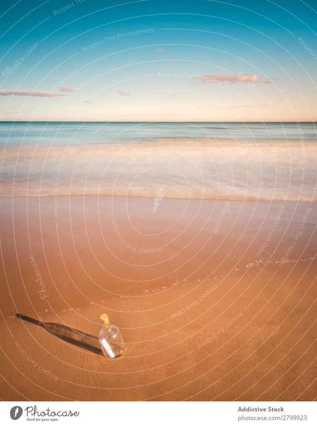 Bottle in sand near sea Letters (alphabet) Sand Ocean Coast Sky Beach Summer Water Vacation & Travel Trip Tourism Deserted Communication Paradise Harmonious