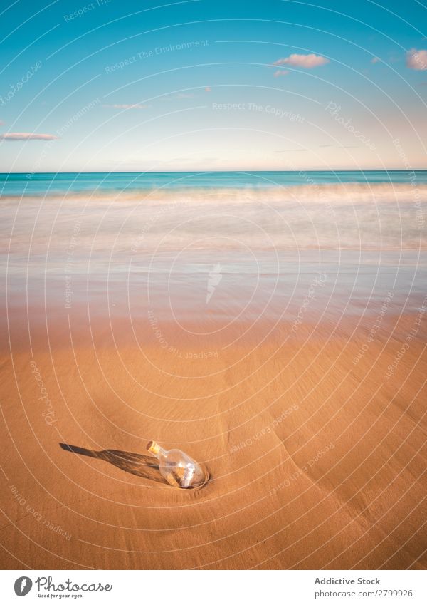 Bottle in sand near sea Letters (alphabet) Sand Ocean Coast Sky Beach Summer Water Vacation & Travel Trip Tourism Deserted Communication Paradise Harmonious