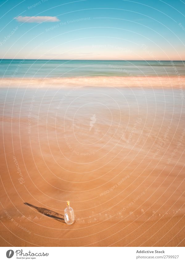 Bottle in sand near sea Letters (alphabet) Sand Ocean Coast Sky Beach Summer Water Vacation & Travel Trip Tourism Deserted Communication Paradise Harmonious