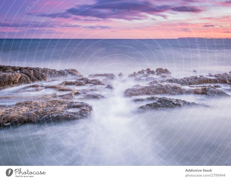 Sea waving near rough rocks during sunset Ocean Rock Waves Sunset Evening Sky Clouds Nature seascape Water Stone Rough rolling Splash Landscape Power Foam