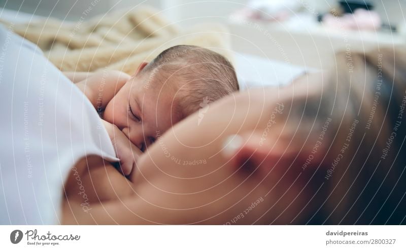 Newborn lying on the bed with her mother Lifestyle Beautiful Child Human being Baby Woman Adults Mother Family & Relations Love Sleep Embrace Authentic Together