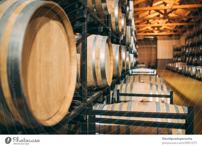 Wood wine barrels stored in a winery on the fermentation process Winery Cellar Vintage oak Storage Drinking Beverage Keg flavor Production Line Factory