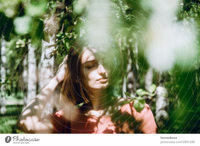 portrait of young white female in blooming trees Aromatic Beautiful Flower Branch Caucasian Woman Fresh Young woman Green Greens Happy Lifestyle Model Nature