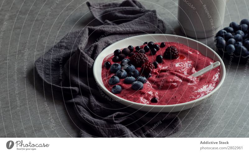 Smoothy of fresh bog blueberries and raspberries in bowl near napkin Milkshake Bowl Mature bog blueberry Raspberry Fresh Napkin Tasty Cup Table Mix Diet To feed