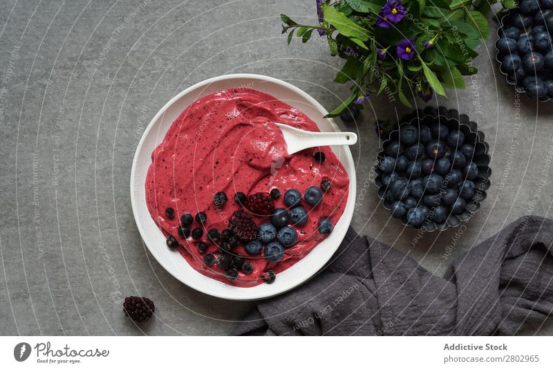 Smoothy of fresh bog blueberries and raspberries in bowl near napkin Milkshake Bowl Mature bog blueberry Raspberry Fresh Napkin Tasty Cup Table Mix Diet To feed