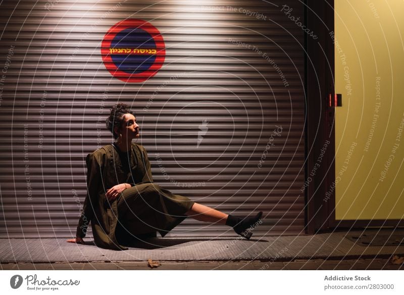 Attractive stylish lady sitting near wall of profiled sheeting Woman Style Hip & trendy Wall (building) Hipster Tel Aviv Israel Night Street Light Posture