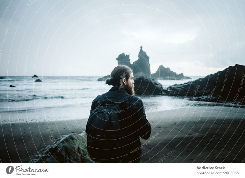 Bearded photographer standing near sea Man photo camera Ocean Vacation & Travel Coast Nature Looking away bearded Waves Storm Landscape Spain playa norte