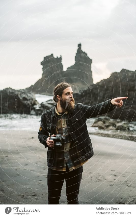 Bearded photographer standing near sea Man photo camera Ocean Vacation & Travel Coast Nature Looking away bearded Waves Storm Landscape Spain playa norte