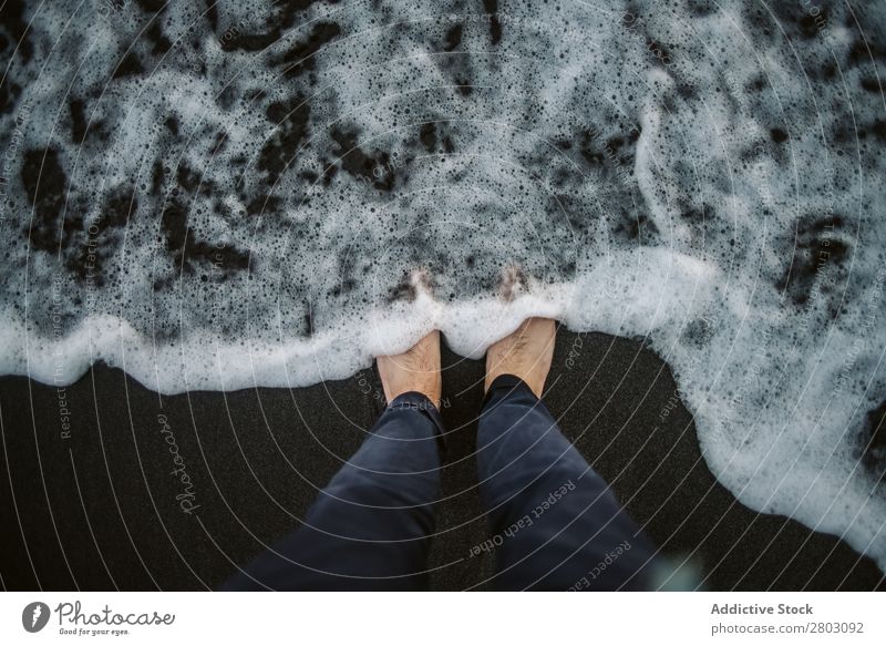 Soft sea foam near barefoot legs Legs Ocean Foam traveler Man Wet Sand Coast Barefoot Water Nature Beach Vacation & Travel playa norte Spain Trip Smooth Waves