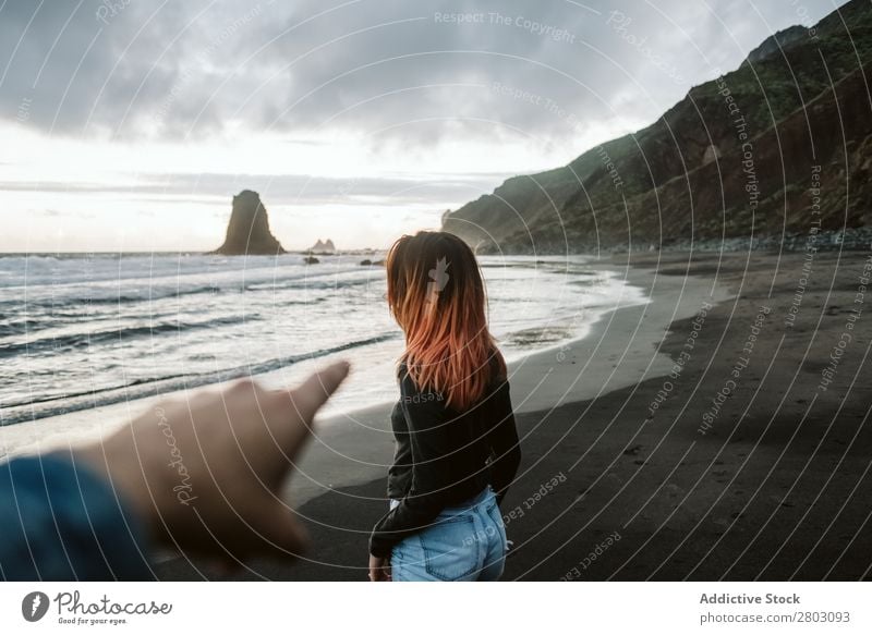 Crop man pointing to a girl on the beach Crops Man Indicate Woman Stand Ocean Coast Storm Waves Clouds Sky Barefoot Vacation & Travel Easygoing Style