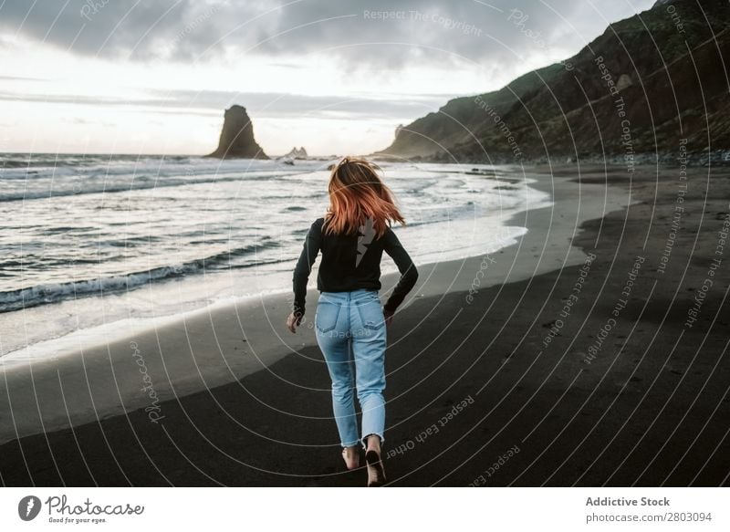 Barefoot female running near waving sea Woman Running Ocean Coast Storm Waves Clouds Sky Vacation & Travel Easygoing Style Hip & trendy Tourism Trip Lifestyle