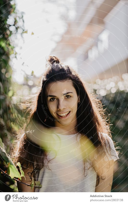 Cheerful woman in garden Woman Backyard Brunette Smiling Bushes Youth (Young adults) Sunbeam Day Gesture Garden Summer Style Easygoing Hip & trendy Park