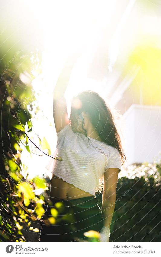 Cheerful woman in garden Woman Backyard Brunette Smiling Bushes Youth (Young adults) Sunbeam Day Gesture Garden Summer Style Easygoing Hip & trendy Park