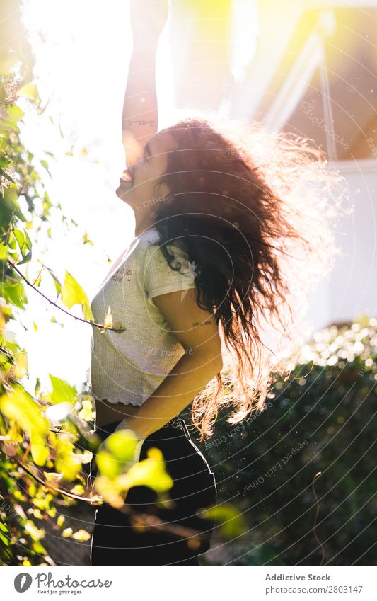 Cheerful woman in garden Woman Backyard Brunette Smiling Bushes Youth (Young adults) Sunbeam Day Gesture Garden Summer Style Easygoing Hip & trendy Park