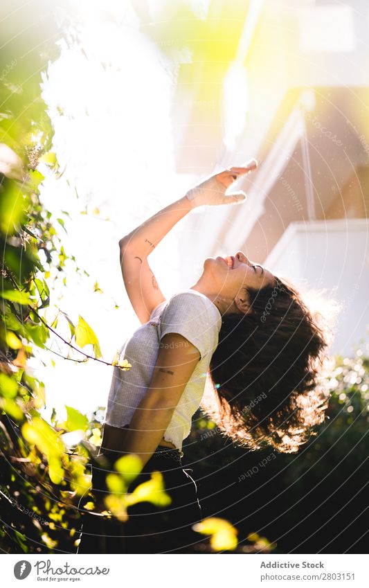 Cheerful woman in garden Woman Backyard Brunette Smiling Bushes Youth (Young adults) Sunbeam Day Gesture Garden Summer Style Easygoing Hip & trendy Park