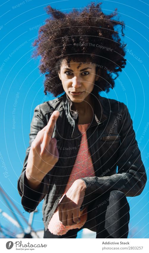 Woman with afro hair making insults. Adults Aggression Aggressive Anger attitude Bad Conceptual design Expression Fingers Gesture Girl Hand Human being Middle