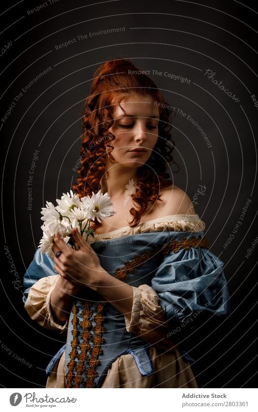 Beautiful woman in medieval clothing Woman Baroque Dress Hold Flower daisies Carnival Renaissance Princess Royal masquerade Fantasy Clothing aristocrat Fashion