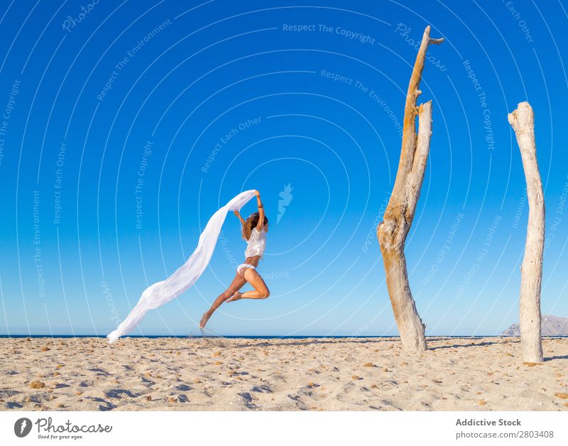 Woman jumping with pareo on beach Beach Rest Jump Summer Vacation & Travel Youth (Young adults) Relaxation Lifestyle Ocean Beautiful Trunk Blue sky