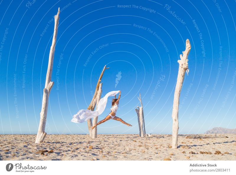 Woman jumping with pareo on beach Beach Rest Jump Summer Vacation & Travel Youth (Young adults) Relaxation Lifestyle Ocean Beautiful Trunk Blue sky