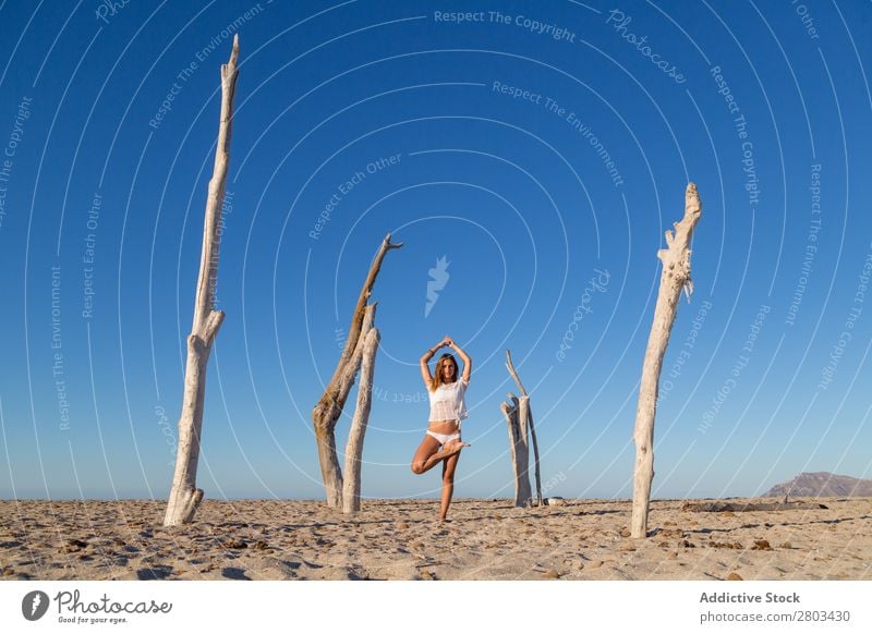 Woman doing yoga on beach Beach Yoga Rest Meditation Summer Vacation & Travel Youth (Young adults) Relaxation asana Peace Practice Balance Fitness Zen Calm