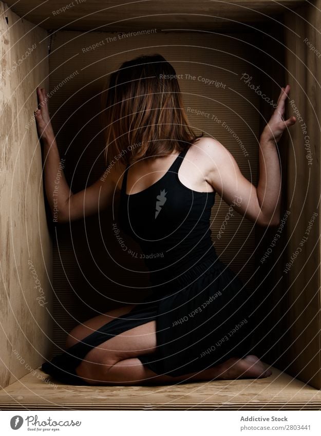 Provocative woman sitting in carton box Woman Alluring Dress Box caption Conceptual design Posture Delightful To enjoy Attractive Model constrained Contemporary