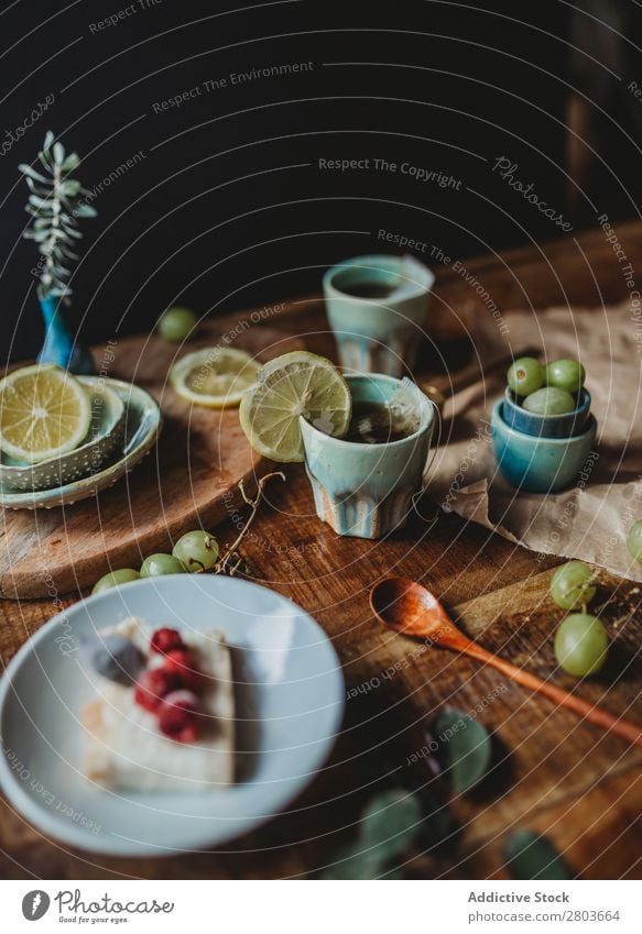 Arrangement of ceramic utensil on wood table Table Bunch of grapes Design Rustic Fresh Lemon Artisan Fruit plates Wood Creativity Natural Self-made