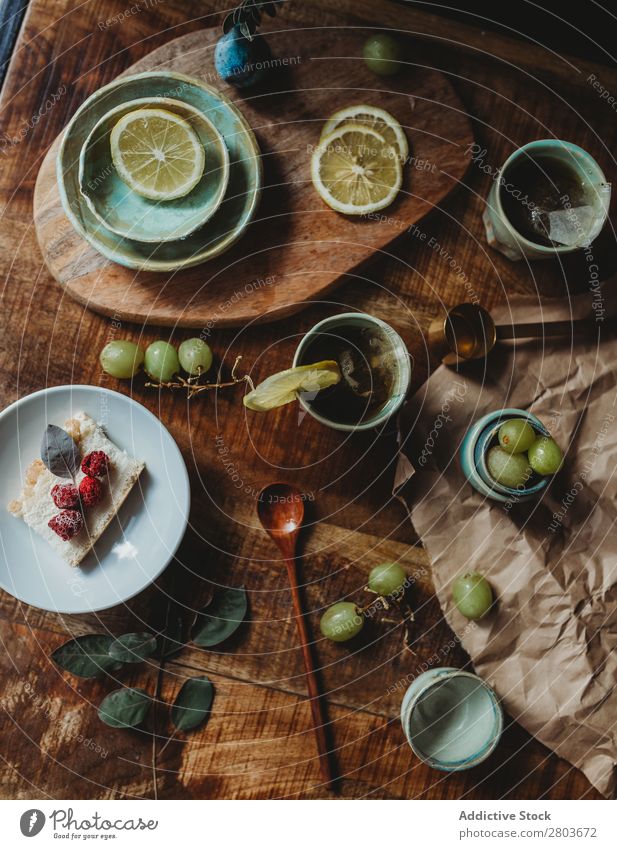 Arrangement of ceramic utensil on wood table Table Bunch of grapes Design Rustic Fresh Lemon Artisan Fruit plates Wood Creativity Natural Self-made