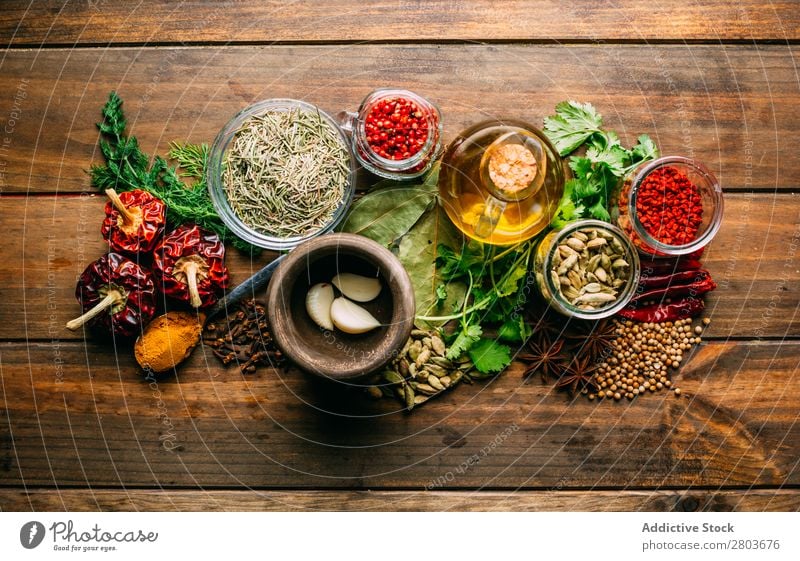 Spices and oil on table Herbs and spices Oil Table assortment Cooking Ingredients Set Fresh Dill Parsley Garlic anise turmeric Cardamom Coriander Chili